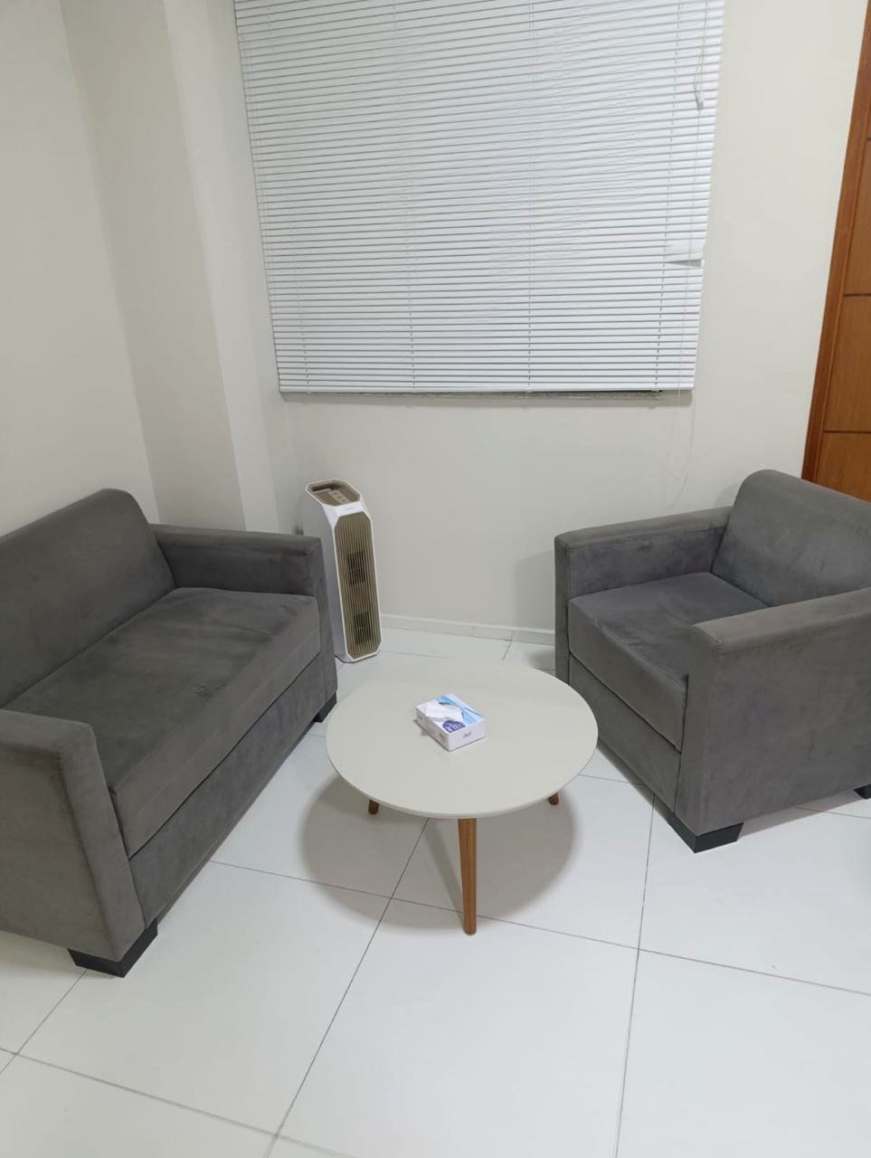 Sala de atendimento, com sofá e poltrona